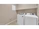 Bright laundry room featuring white washer and dryer at 2987 E Powell Way, Gilbert, AZ 85298