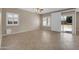 Open-concept living area featuring tiled flooring, windows, and sliding glass doors to the backyard at 2987 E Powell Way, Gilbert, AZ 85298