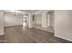 Open-concept living space featuring elegant archways, wood flooring, and tile flooring at 2987 E Powell Way, Gilbert, AZ 85298