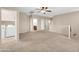Spacious loft area featuring neutral carpet, ceiling fan, and convenient access to laundry and bathroom at 2987 E Powell Way, Gilbert, AZ 85298
