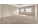 Spacious bedroom with a ceiling fan and natural light streaming through shuttered windows at 2987 E Powell Way, Gilbert, AZ 85298