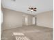 Spacious main bedroom with plush carpeting, ceiling fan, neutral walls and walk-in closet access at 2987 E Powell Way, Gilbert, AZ 85298