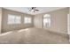 Bright and airy bedroom featuring plush carpeting, a ceiling fan, and ample natural light at 2987 E Powell Way, Gilbert, AZ 85298
