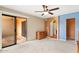 This bedroom features a ceiling fan, sliding glass doors to a balcony, and a small storage chest at 3031 N Civic Center Plz # 205, Scottsdale, AZ 85251
