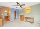 This bedroom features an archway to a bathroom, ceiling fan, and blue accent wall at 3031 N Civic Center Plz # 205, Scottsdale, AZ 85251