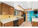 Bright kitchen with wood cabinets and black appliances at 3031 N Civic Center Plz # 205, Scottsdale, AZ 85251