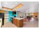 Open kitchen with breakfast bar and access to the living room, fireplace, and balcony at 3031 N Civic Center Plz # 205, Scottsdale, AZ 85251