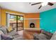 Cozy living room with fireplace and sliding glass doors to the outdoor balcony at 3031 N Civic Center Plz # 205, Scottsdale, AZ 85251