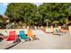 Relaxing pool deck area with colorful lounge chairs and well-maintained landscaping at 3031 N Civic Center Plz # 205, Scottsdale, AZ 85251