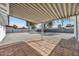 A covered patio overlooks the expansive backyard with gravel groundcover and block fencing at 3037 E Pueblo Ave, Mesa, AZ 85204