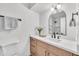 Bright bathroom with a vanity, elegant mirror, and fresh flowers on the countertop, adding a touch of sophistication at 3037 E Pueblo Ave, Mesa, AZ 85204