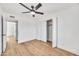 Bright bedroom features modern ceiling fan, closet, wood-look floors, and white walls at 3037 E Pueblo Ave, Mesa, AZ 85204