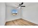 The bedroom has a lot of light, a black ceiling fan, neutral paint, and wood-look flooring at 3037 E Pueblo Ave, Mesa, AZ 85204