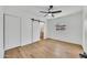 The bedroom has plenty of natural light, neutral paint, and light wood-look flooring at 3037 E Pueblo Ave, Mesa, AZ 85204