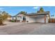 Charming single-story home with a long driveway, covered parking, and low maintenance landscaping at 3037 E Pueblo Ave, Mesa, AZ 85204