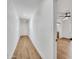 Hallway with clean white walls and light wood-look flooring leads to other rooms in the house at 3037 E Pueblo Ave, Mesa, AZ 85204