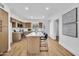 Bright kitchen featuring stainless steel appliances, light wood cabinets, and a white countertop island with seating at 3037 E Pueblo Ave, Mesa, AZ 85204