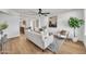 Comfortable living room featuring stylish furniture, modern decor, an open concept, and a ceiling fan with bright light at 3037 E Pueblo Ave, Mesa, AZ 85204