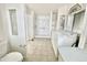 Well-lit bathroom features a step-in shower, commode and in-unit laundry at 318 S Crismon Rd # 83, Mesa, AZ 85208
