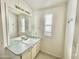 Functional bathroom with a vanity, large mirror, and natural light from a window at 318 S Crismon Rd # 83, Mesa, AZ 85208