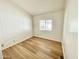 Cozy bedroom featuring wood-look flooring and a window providing natural light at 318 S Crismon Rd # 83, Mesa, AZ 85208