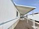 Long carport attached to the side of a mobile home, providing covered parking at 318 S Crismon Rd # 83, Mesa, AZ 85208