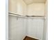 Walk-in closet features ample storage with shelving and a hanging rod, maximizing organization at 318 S Crismon Rd # 83, Mesa, AZ 85208