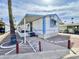 Charming home exterior featuring covered porch, desert landscaping, and blue and white accents at 318 S Crismon Rd # 83, Mesa, AZ 85208