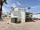Mobile home exterior with gravel yard, carport, and visible air conditioning unit at 318 S Crismon Rd # 83, Mesa, AZ 85208
