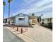 Charming exterior of home with covered parking, desert landscaping, and blue and white accents at 318 S Crismon Rd # 83, Mesa, AZ 85208