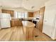 Cozy kitchen with wood cabinets, island, and appliances providing functionality and charm at 318 S Crismon Rd # 83, Mesa, AZ 85208