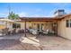 Backyard patio with seating areas, featuring brick and stone flooring and a covered area with outdoor furnishings at 3221 N 41St Pl, Phoenix, AZ 85018
