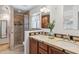 Bathroom featuring a dual sink vanity, stone countertops, and a glass shower enclosure at 3221 N 41St Pl, Phoenix, AZ 85018