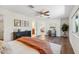 Bright bedroom with a desk, ceiling fan, white walls, and wood-look floors at 3221 N 41St Pl, Phoenix, AZ 85018