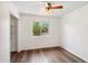 Empty bedroom with wood-look floors, a bright window with an outdoor view, and closet at 3221 N 41St Pl, Phoenix, AZ 85018