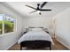 Comfortable bedroom with wood-look floors, ceiling fan, and bright natural light from the window at 3221 N 41St Pl, Phoenix, AZ 85018