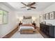 Bright bedroom featuring a ceiling fan, bedside tables with lamps, and minimalist decor at 3221 N 41St Pl, Phoenix, AZ 85018