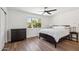 Bedroom with wood-look floors, ceiling fan, dresser, and bright window with a backyard view at 3221 N 41St Pl, Phoenix, AZ 85018