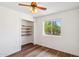 Empty bedroom with wood-look floors, a window with outdoor view, and closet with shelves at 3221 N 41St Pl, Phoenix, AZ 85018