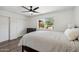 Bedroom featuring wood-look floors, ceiling fan, closet, and bright window with a backyard view at 3221 N 41St Pl, Phoenix, AZ 85018