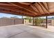 Spacious covered patio, perfect for parking or outdoor gatherings, leading to a backyard with mature landscaping at 3221 N 41St Pl, Phoenix, AZ 85018