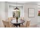 Bright dining area with hardwood table, four upholstered chairs, and a large window overlooking outdoor foliage at 3221 N 41St Pl, Phoenix, AZ 85018