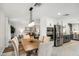 Dining room with adjacent kitchen has an eating area with a modern light fixture and neutral colored walls at 3221 N 41St Pl, Phoenix, AZ 85018