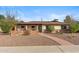Charming single-story home with desert landscaping, brick accents and covered porch with seating area at 3221 N 41St Pl, Phoenix, AZ 85018