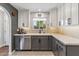 Well-lit kitchen features two-tone cabinets, quartz countertops, stainless steel appliances, and tile backsplash at 3221 N 41St Pl, Phoenix, AZ 85018