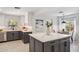 Bright open kitchen features an island with a white countertop, gray lower cabinets, and stainless appliances at 3221 N 41St Pl, Phoenix, AZ 85018