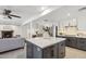 Open kitchen area features gray cabinetry, a center island, and a view into the living and dining rooms at 3221 N 41St Pl, Phoenix, AZ 85018
