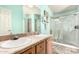 Bright bathroom featuring dual sinks, modern fixtures, and a glass-enclosed shower for a spa-like experience at 3301 S Goldfield Rd # 2034, Apache Junction, AZ 85119