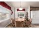 Cozy dining area with lots of natural light, featuring a wood table with seating for four and a white refrigerator at 3301 S Goldfield Rd # 2034, Apache Junction, AZ 85119