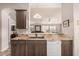 Well-lit kitchen with granite countertops, cabinets and a white dishwasher offering a clean and functional space at 3301 S Goldfield Rd # 2034, Apache Junction, AZ 85119